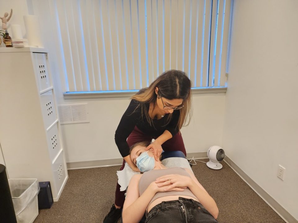 Dr. Sabbaghan working on a patient's neck in a chiropractic treatment session.